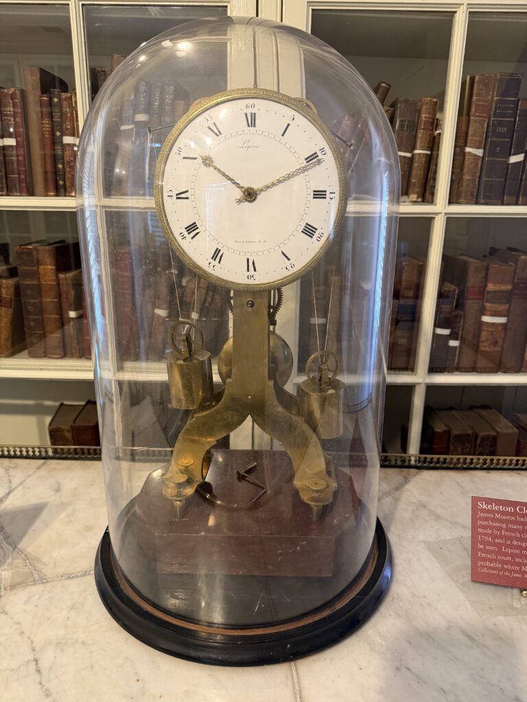 An intricate clock mechanism on display through a glass vase