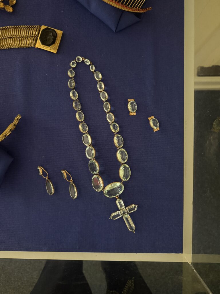A necklace made out of Citrine aid out to show the gemstone collar and cross feature