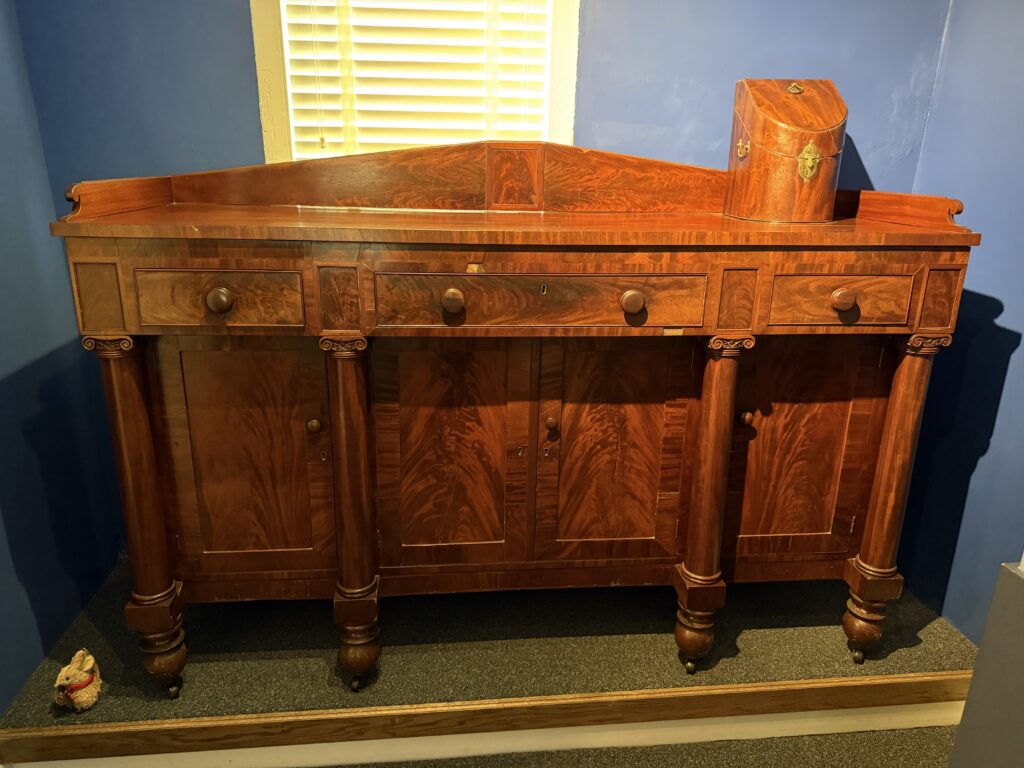 A large Oak Board dresser featuring many cubbies and compartments to hold various items